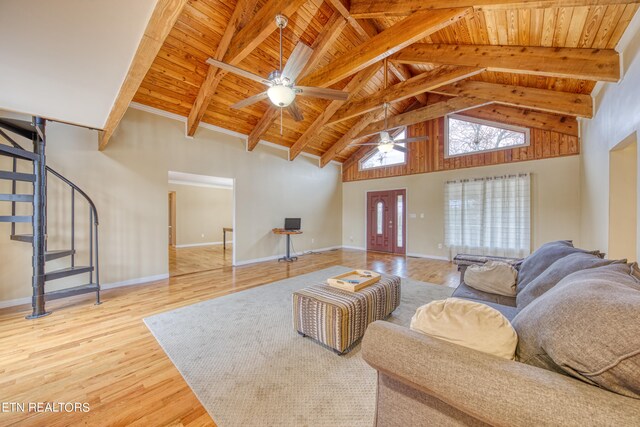 living room featuring ceiling fan, light hardwood / wood-style flooring, wood ceiling, and beamed ceiling