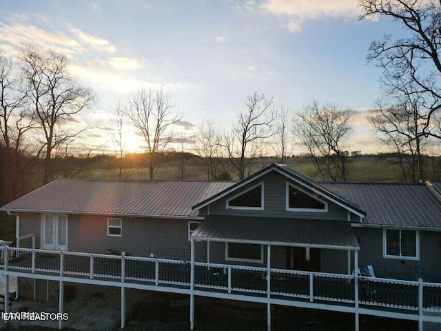 view of back house at dusk