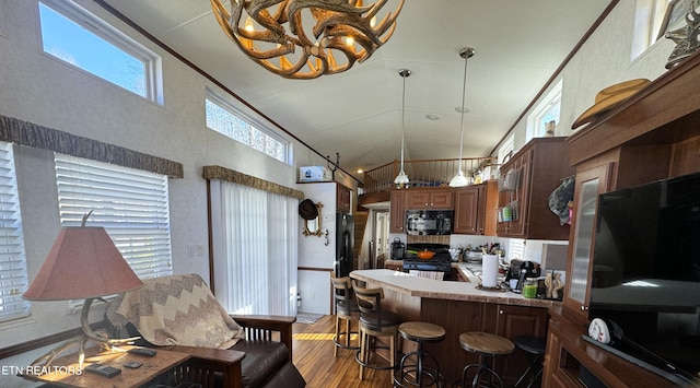 kitchen with high vaulted ceiling, light hardwood / wood-style flooring, black appliances, and plenty of natural light