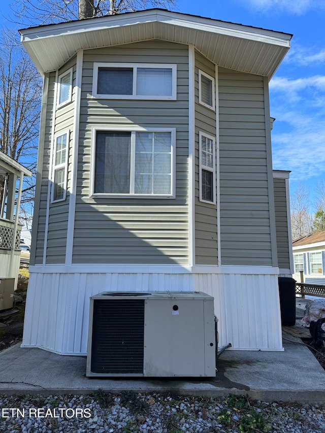 view of side of property featuring central AC unit