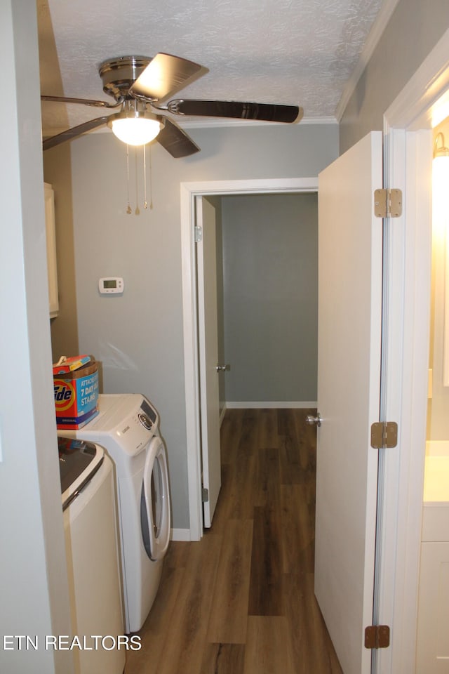 washroom with a textured ceiling, separate washer and dryer, ceiling fan, and dark hardwood / wood-style flooring