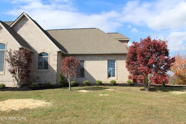 view of side of property featuring a yard