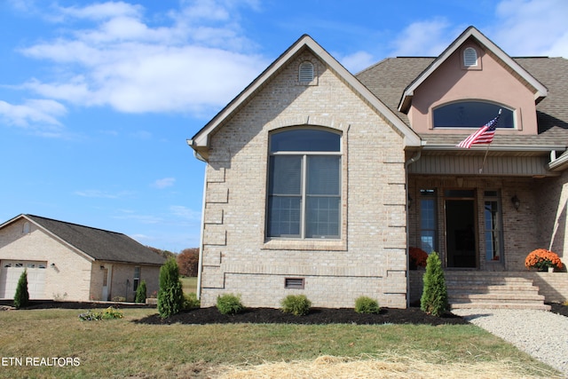 french country inspired facade featuring covered porch and a front lawn