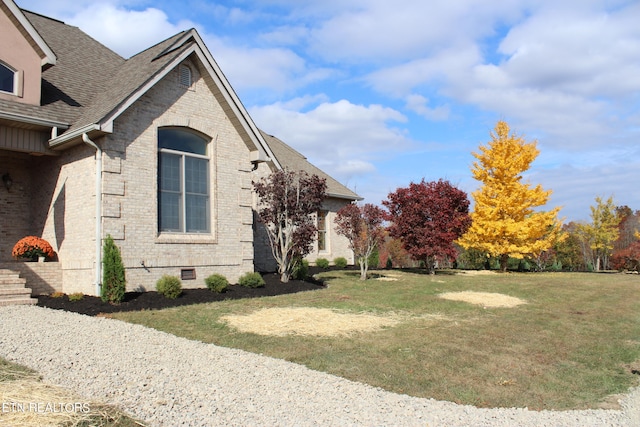 view of property exterior with a lawn