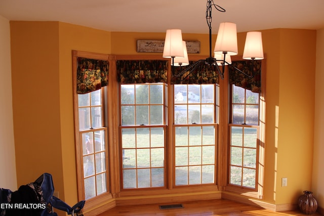 details featuring a notable chandelier and wood-type flooring