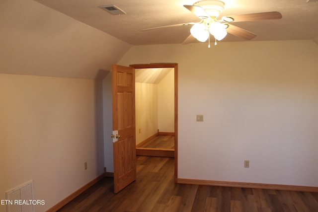 interior space with ceiling fan, dark wood-type flooring, and vaulted ceiling