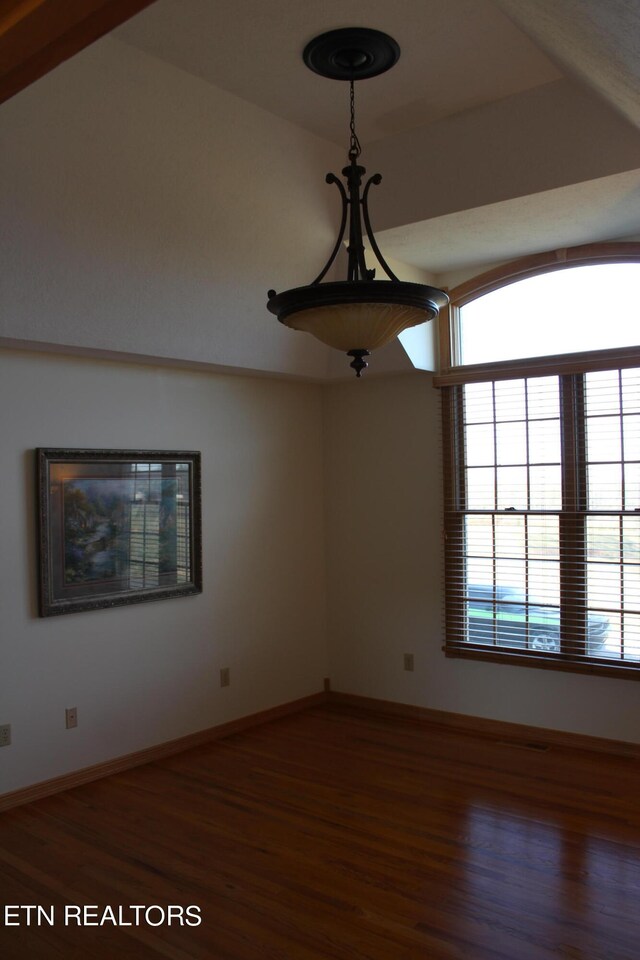 unfurnished room with dark hardwood / wood-style flooring