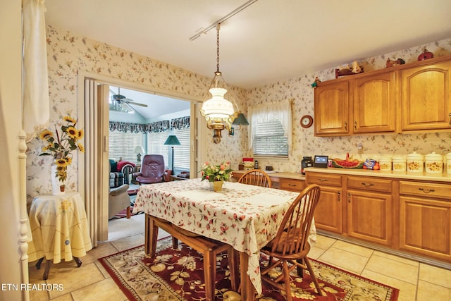 tiled dining space featuring ceiling fan