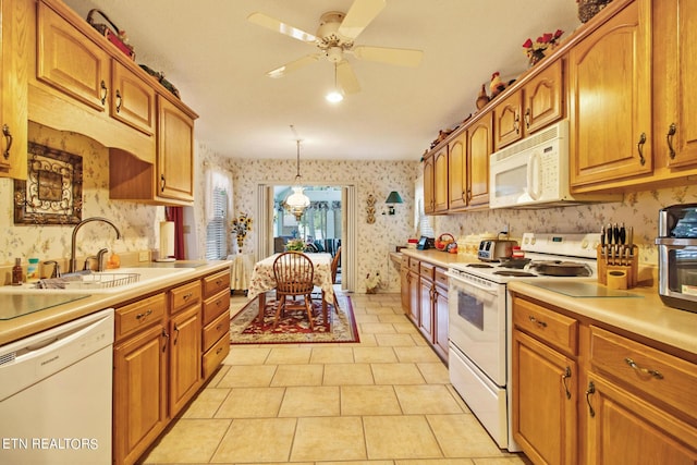 kitchen with light tile patterned flooring, sink, ceiling fan, pendant lighting, and white appliances