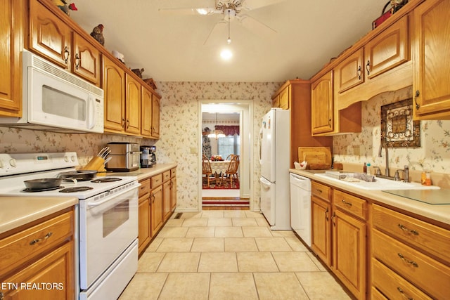 kitchen featuring ceiling fan, white appliances, light tile patterned flooring, and sink