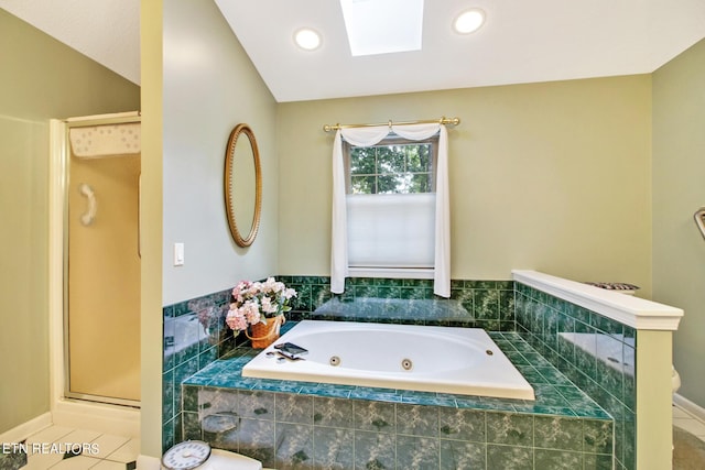 bathroom featuring tile patterned flooring, a skylight, and independent shower and bath