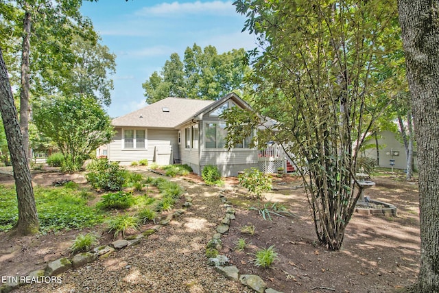 rear view of property featuring a wooden deck