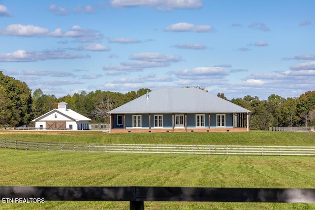 view of front facade with a front lawn and a rural view