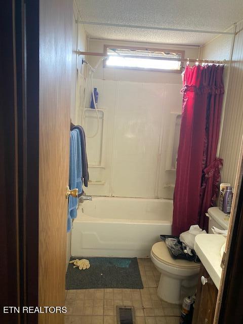 full bathroom featuring shower / tub combo, vanity, toilet, and tile floors