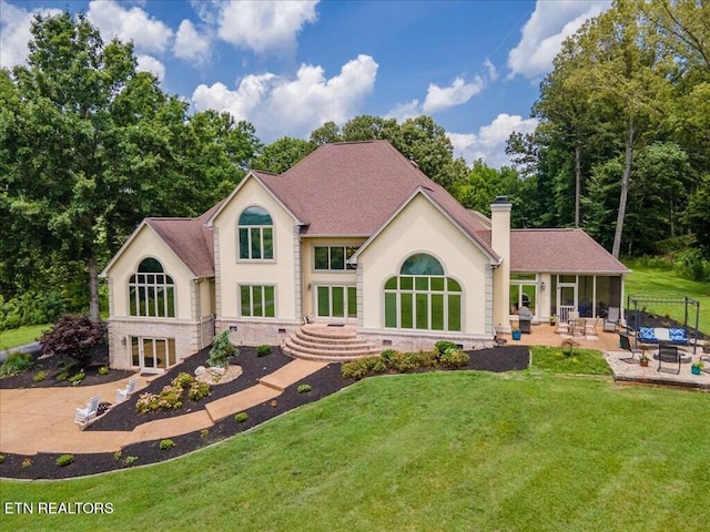 exterior space featuring a lawn and a patio area