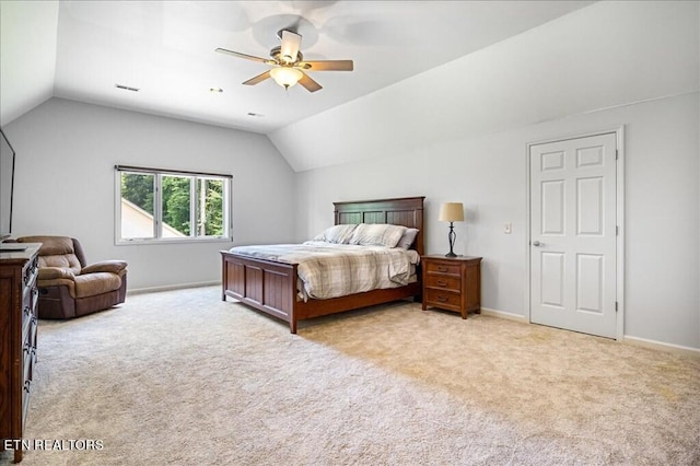 bedroom featuring light carpet, lofted ceiling, and ceiling fan