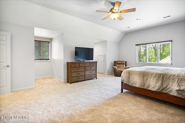 bedroom featuring ceiling fan, lofted ceiling, and light colored carpet