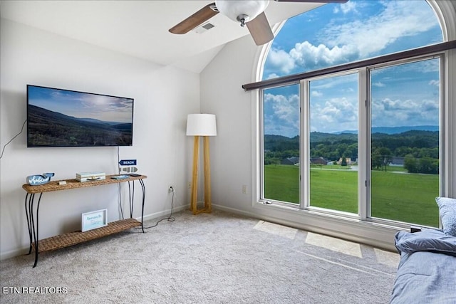 living room featuring light carpet, vaulted ceiling, a mountain view, and ceiling fan