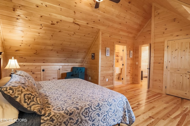 bedroom with wood ceiling, wood walls, lofted ceiling, light wood-type flooring, and ensuite bath