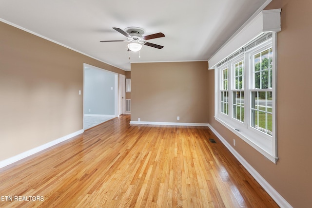 unfurnished room featuring crown molding, ceiling fan, and light wood-type flooring