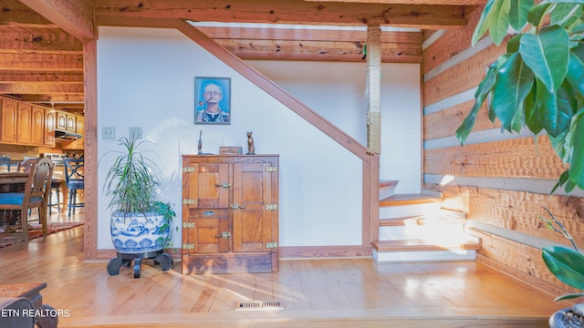 interior space with hardwood / wood-style floors and beam ceiling