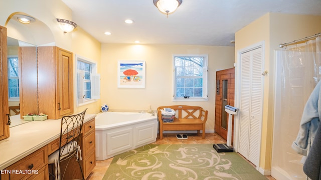 bathroom featuring tile floors and a bathtub