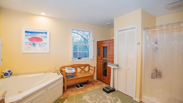 bathroom featuring tile floors and a bath to relax in