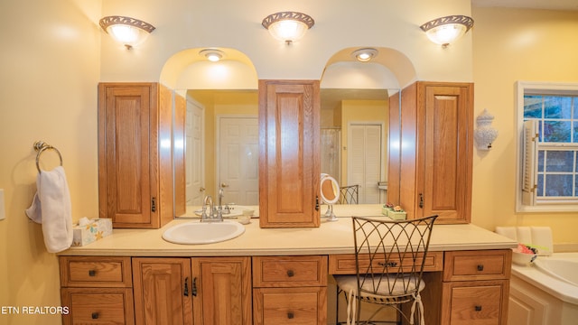 bathroom featuring vanity and a bath to relax in