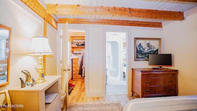 bedroom featuring beam ceiling and light tile flooring