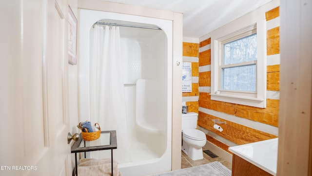 bathroom featuring vanity, toilet, and tile floors