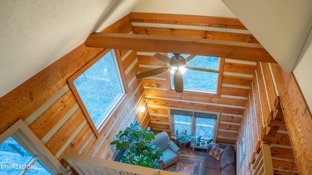 living room featuring ceiling fan and lofted ceiling