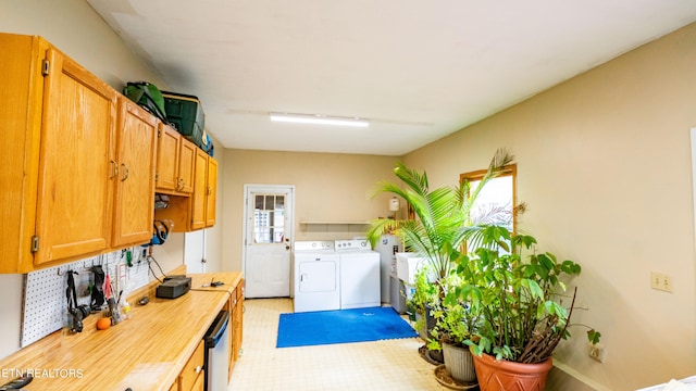 kitchen featuring backsplash, washer and clothes dryer, and light tile floors