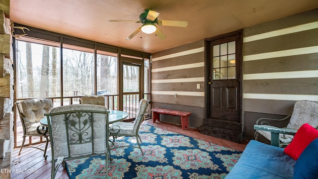 sunroom featuring a wealth of natural light and ceiling fan