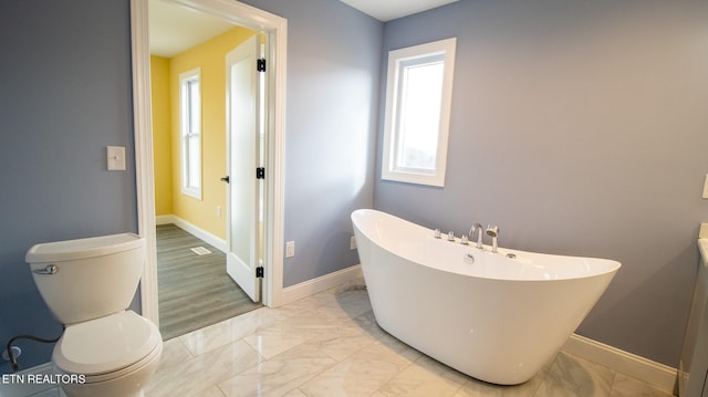 bathroom featuring toilet and tile flooring