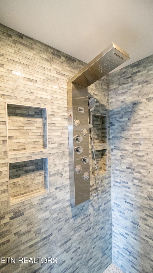 bathroom with a tile shower