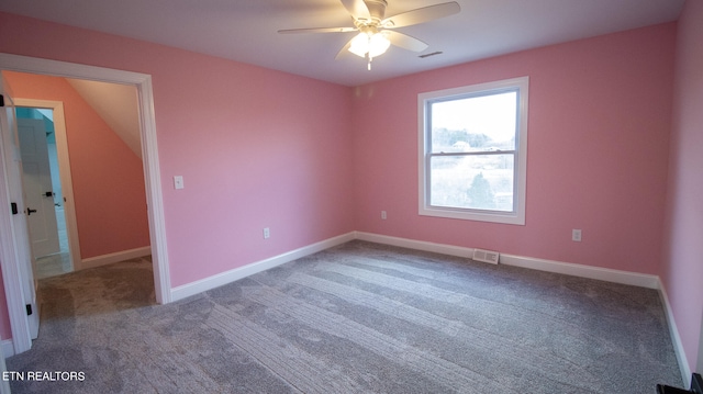 carpeted spare room featuring ceiling fan