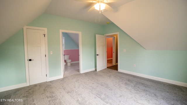 bonus room with ceiling fan, light carpet, and vaulted ceiling