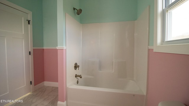 bathroom featuring tile floors and tub / shower combination