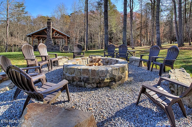 view of terrace with a gazebo and a fire pit