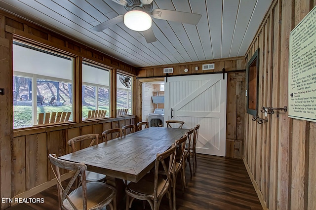 sunroom featuring a barn door and ceiling fan