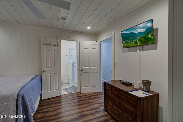 bedroom featuring ensuite bath and dark hardwood / wood-style floors