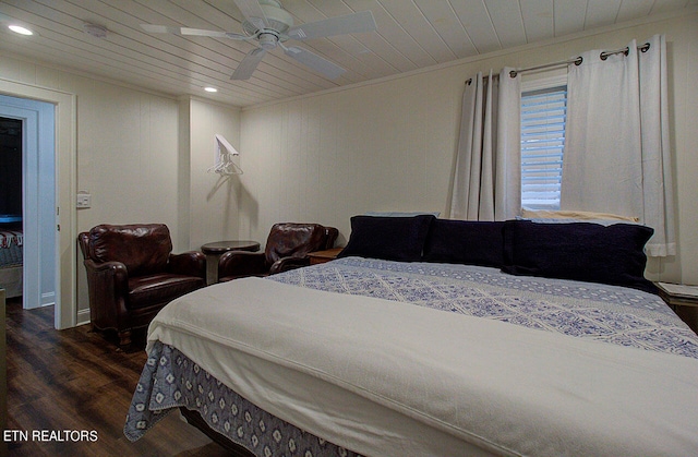 bedroom with ceiling fan, dark hardwood / wood-style floors, and wood ceiling