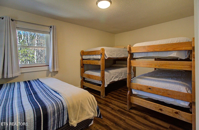 bedroom with dark wood-type flooring