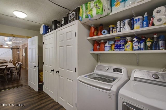 washroom with independent washer and dryer, dark wood-type flooring, and a textured ceiling