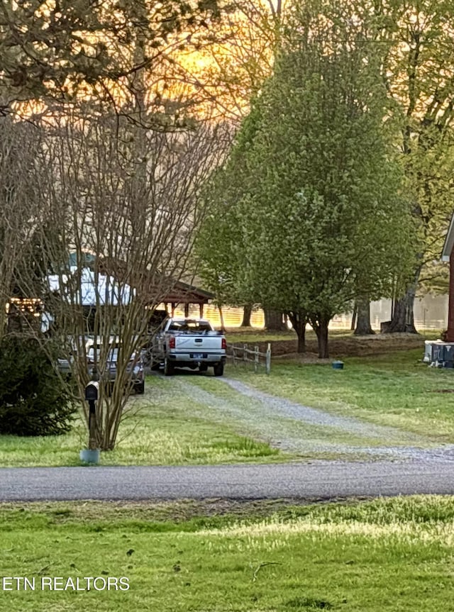 exterior space with driveway and a front yard