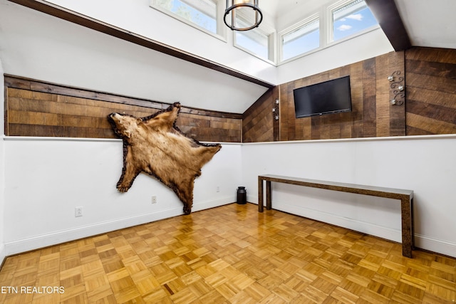 interior space featuring baseboards and vaulted ceiling