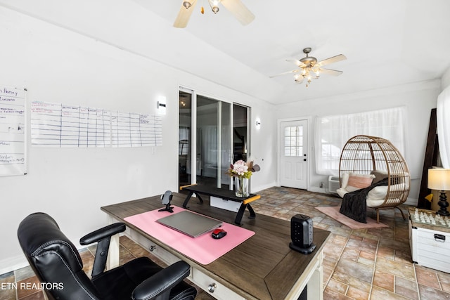 home office featuring stone finish flooring, baseboards, and a ceiling fan