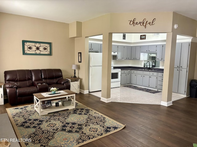living area with dark wood finished floors and baseboards