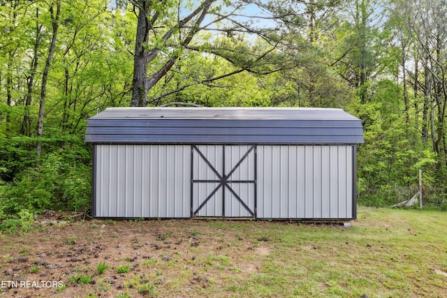 view of shed with a view of trees