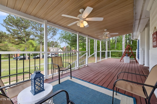 wooden deck featuring a ceiling fan